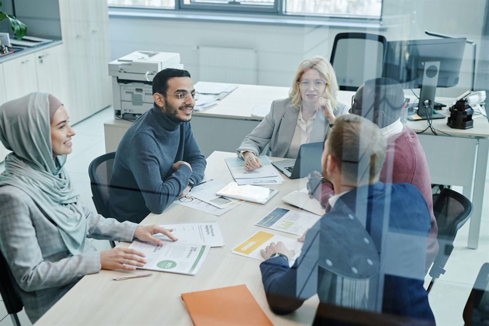 Marketing team meeting around a table in a bright office