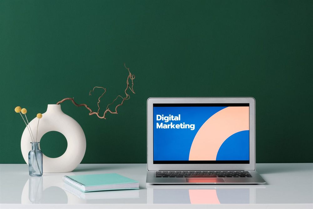 Laptop showing a digital marketing slide on a white desk