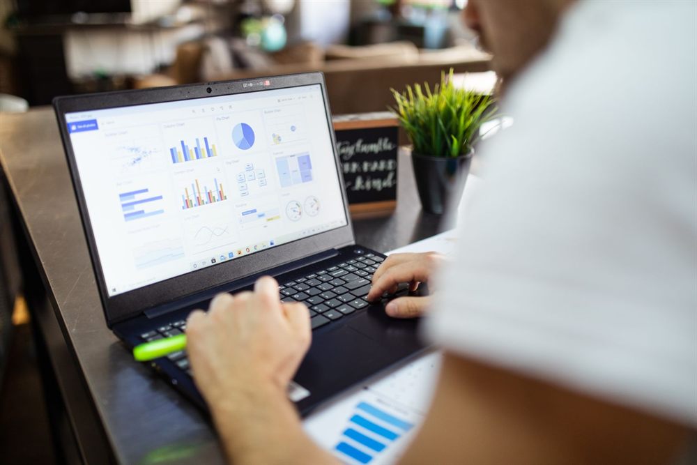 Person reviewing website analytics charts on a laptop